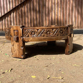 a wooden bench sitting on a sandy beach